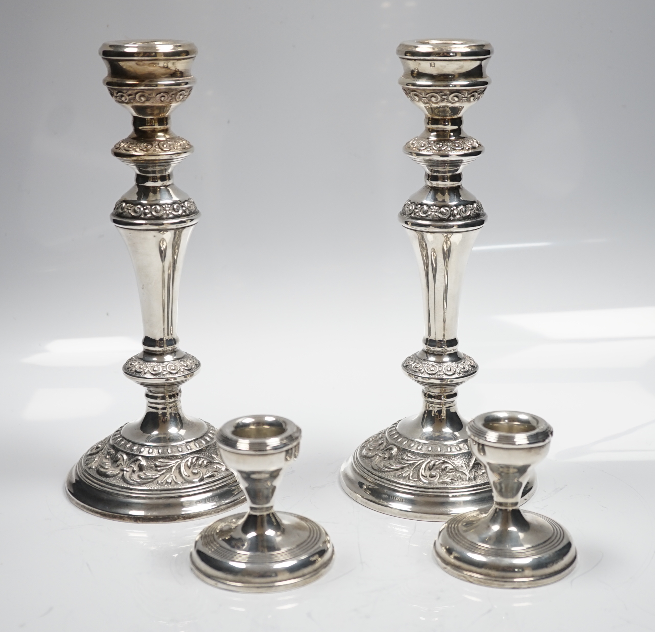 A modern pair of silver mounted candlesticks, Broadway & Co, Birmingham, 1991, 22.23cm and a pair of silver mounted dwarf candlesticks.